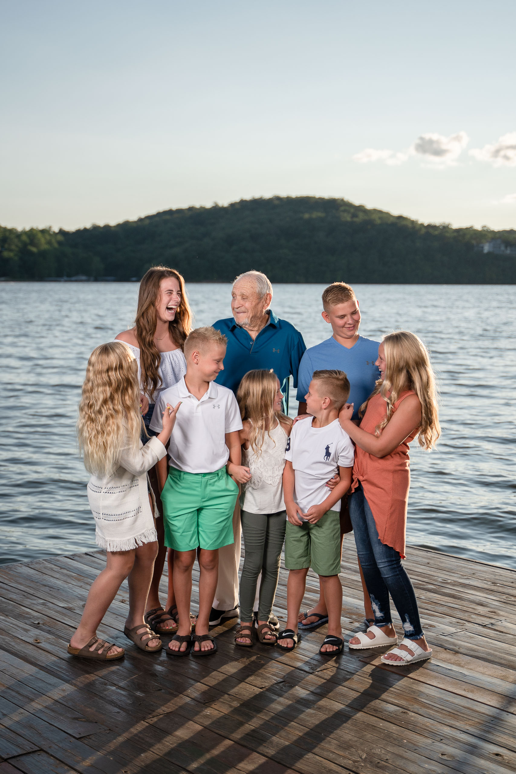 Lake of the Ozarks Family Photographer family laughing on a dock